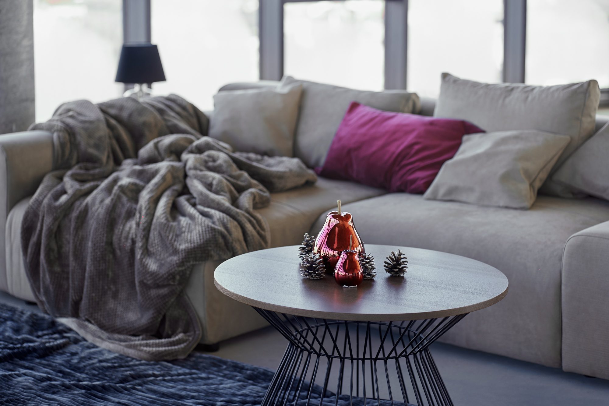 Modern sofa with cozy pillows at home with stylish interior.